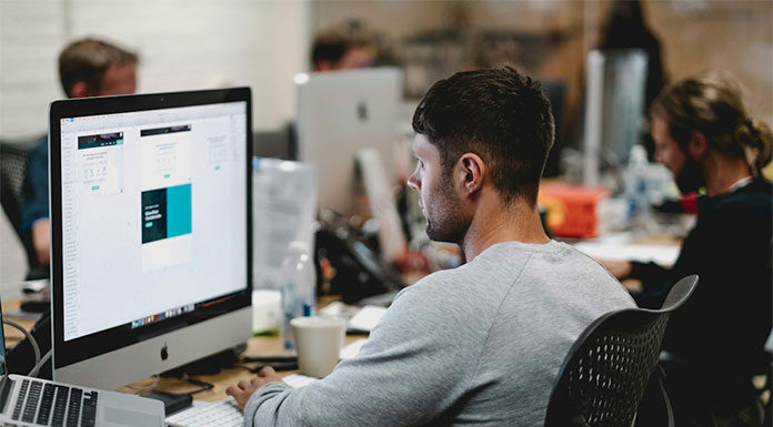 A person working on a computer using AI knowledge management systems